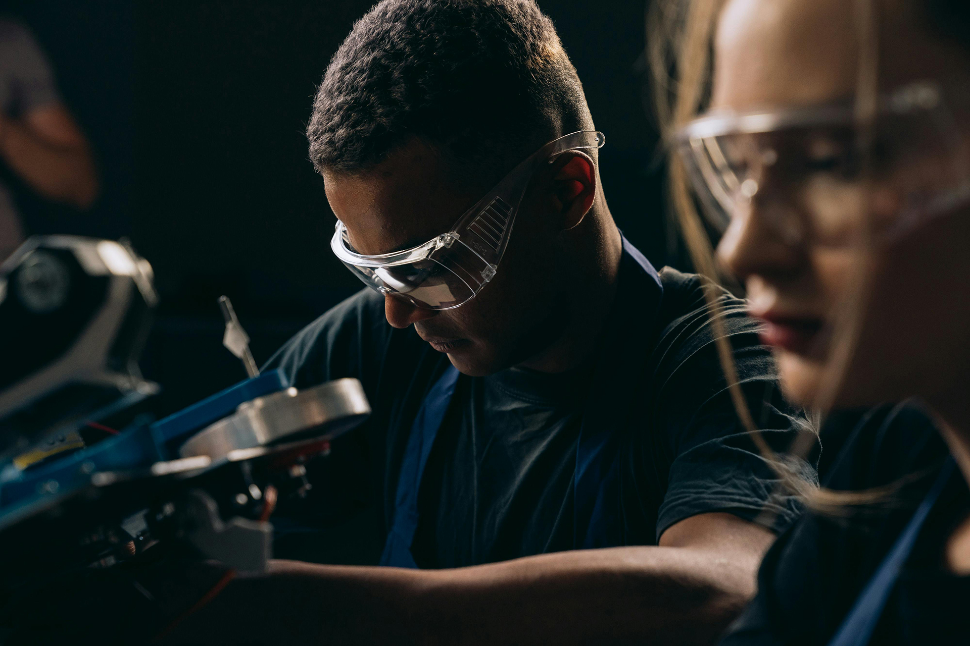 Learners in a technical training academy working on some tools